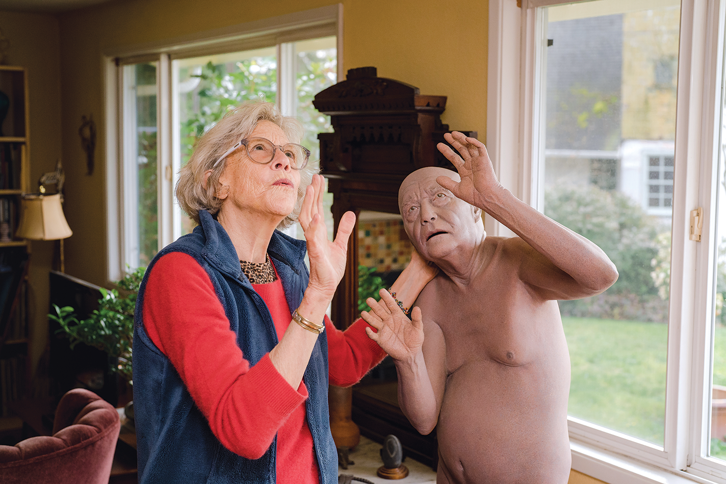 Tip Toland poses with her sculpture.