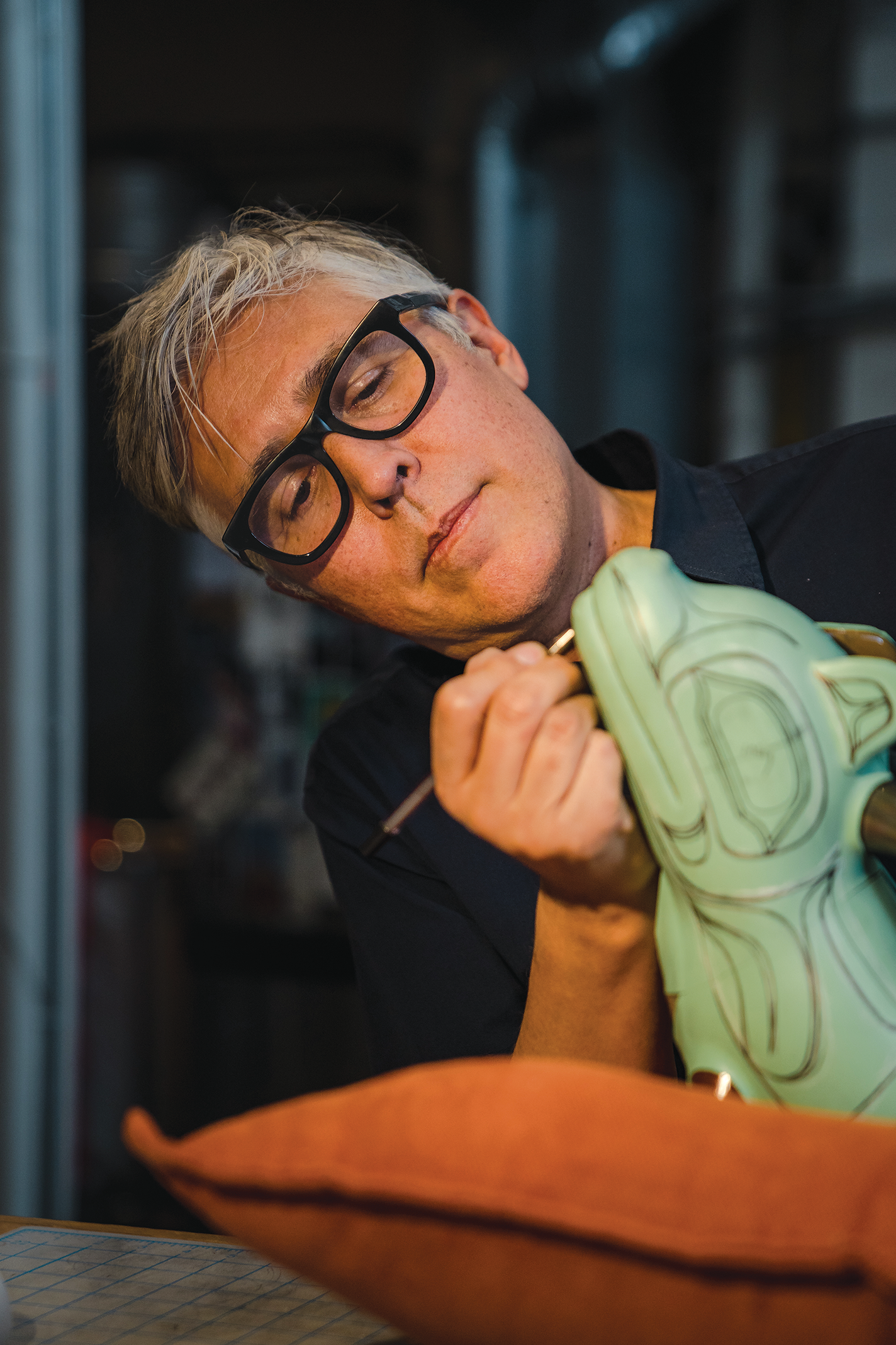 Preston Singletary works on a glass sculpture.