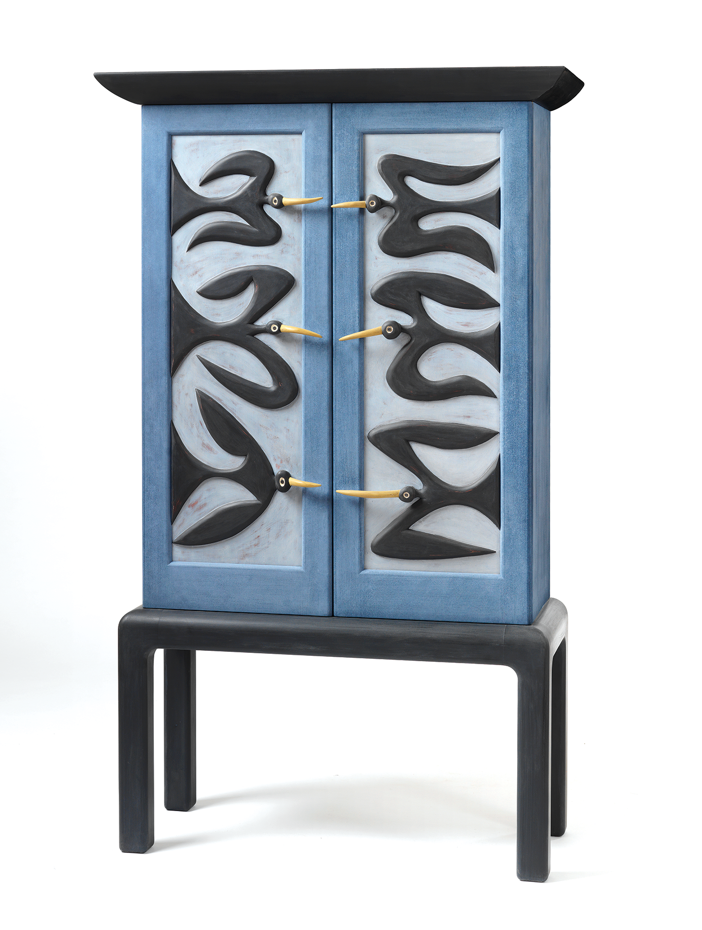 Blue-painted wood cabinet with blackbirds, whose beaks are the cabinet handles