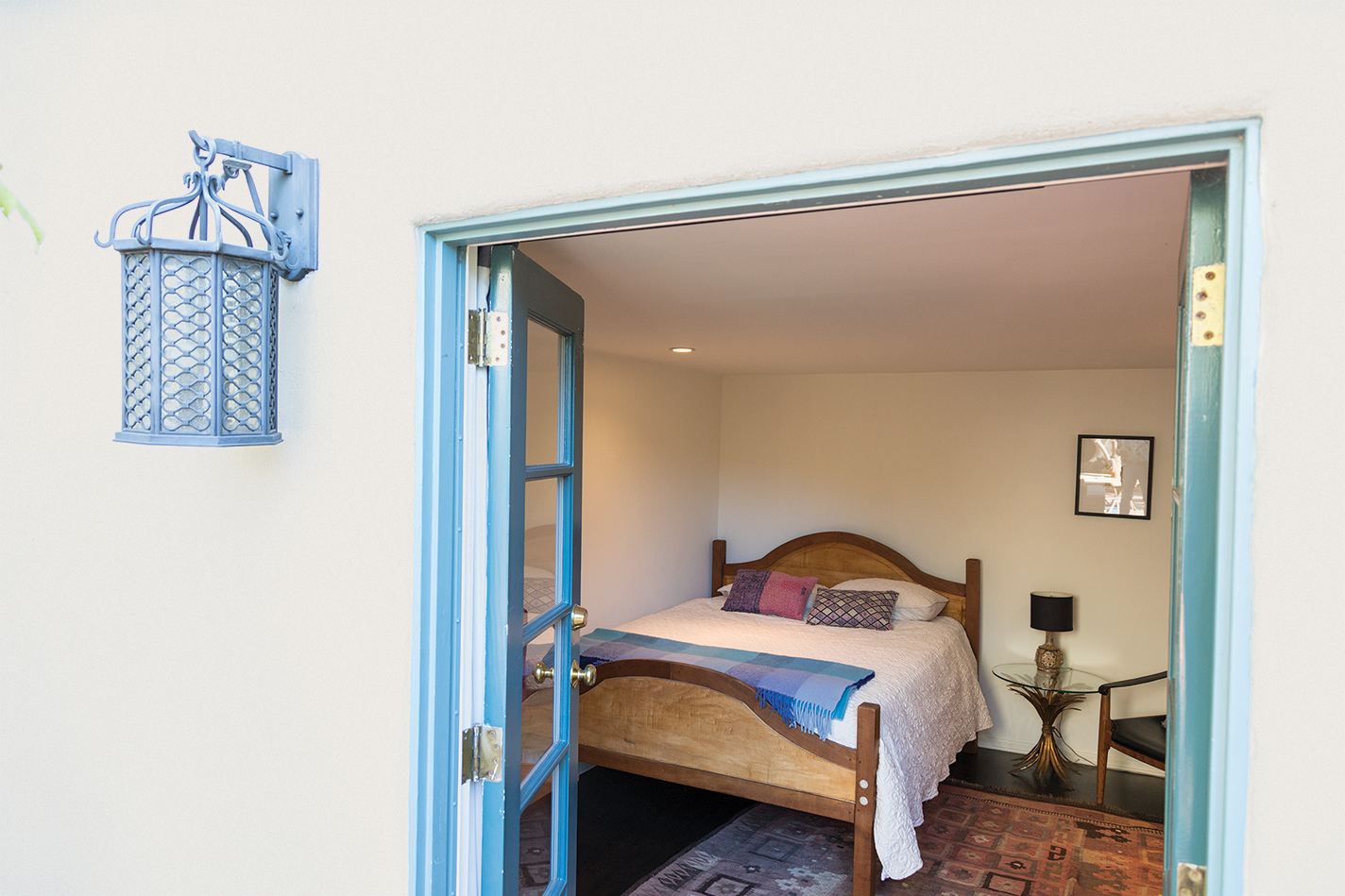 Handmade maple-and-cherry bed in a guest room