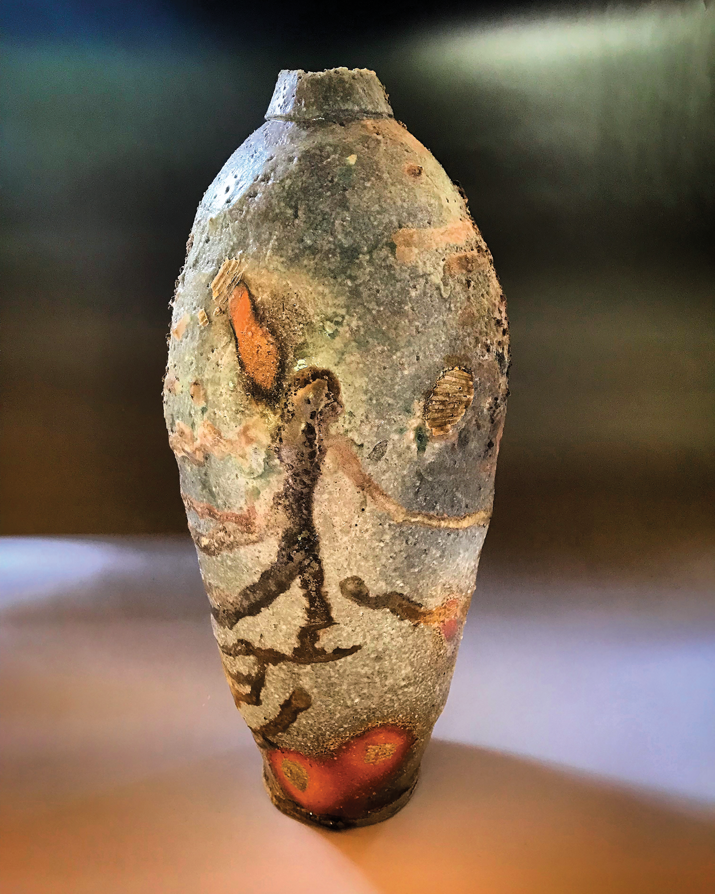 Wood-fired ceramic bottle with complex textured surface