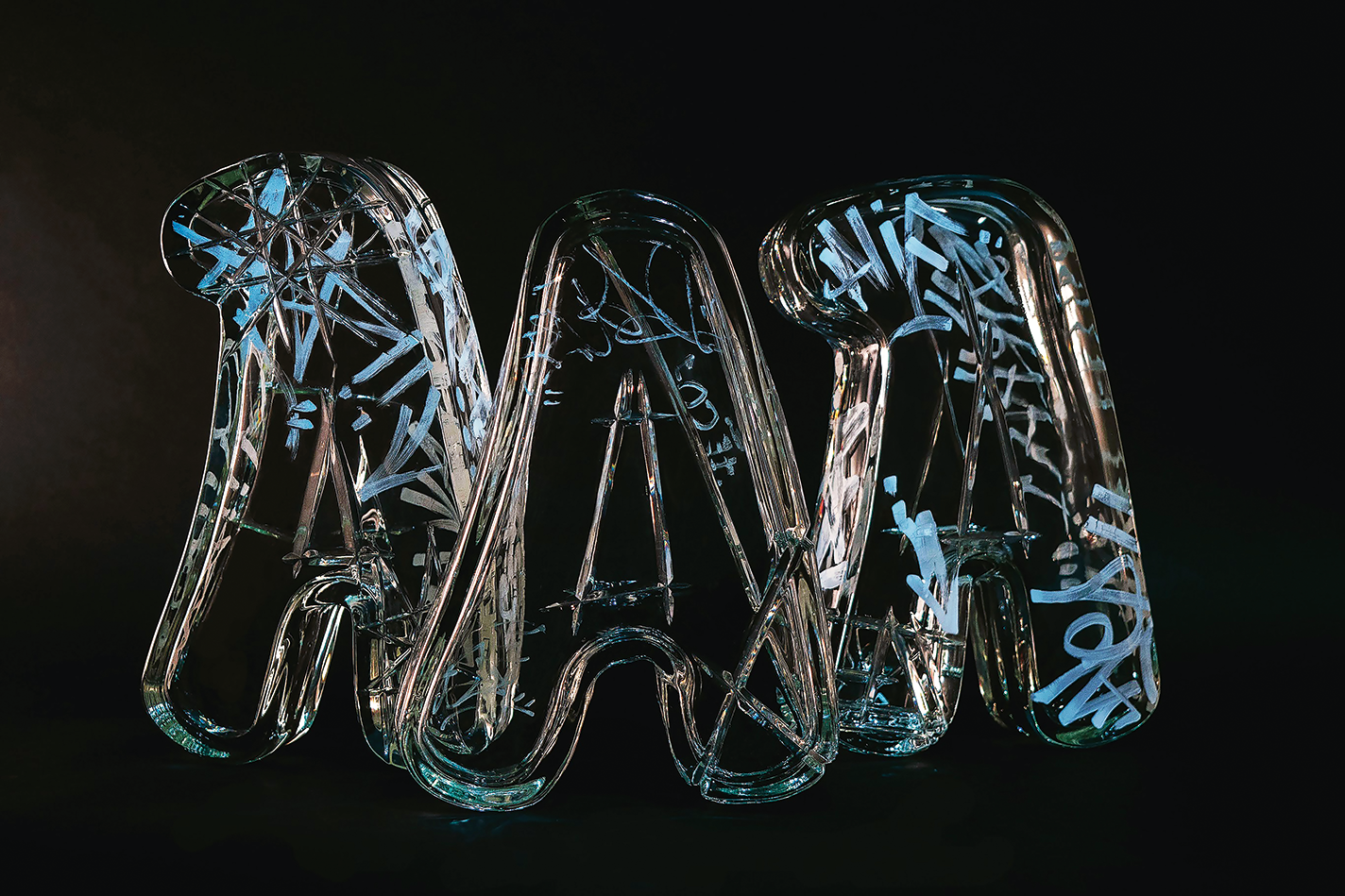 Three A's in clear blown glass.