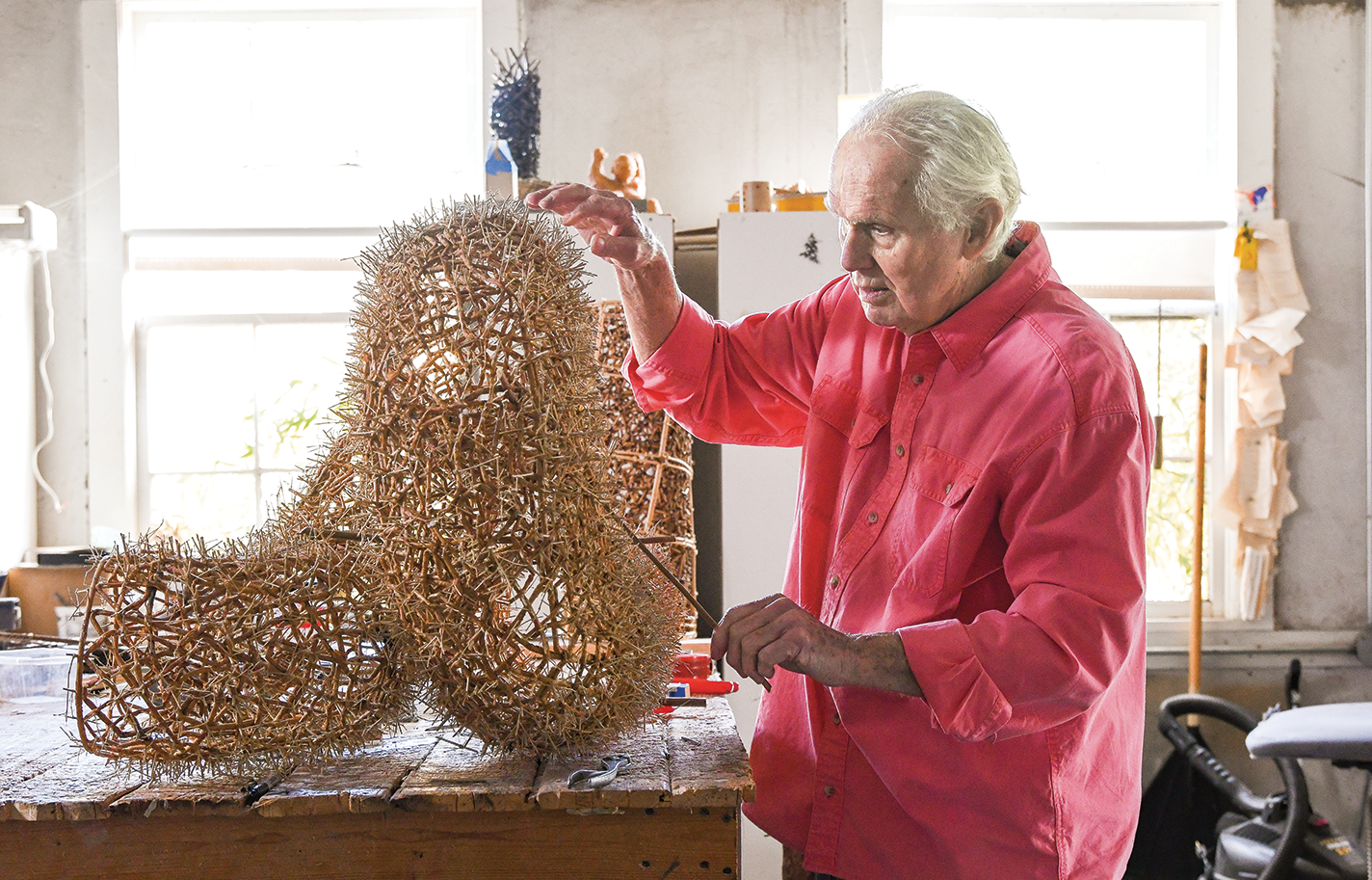 John McQueen works on a sculptural basket.