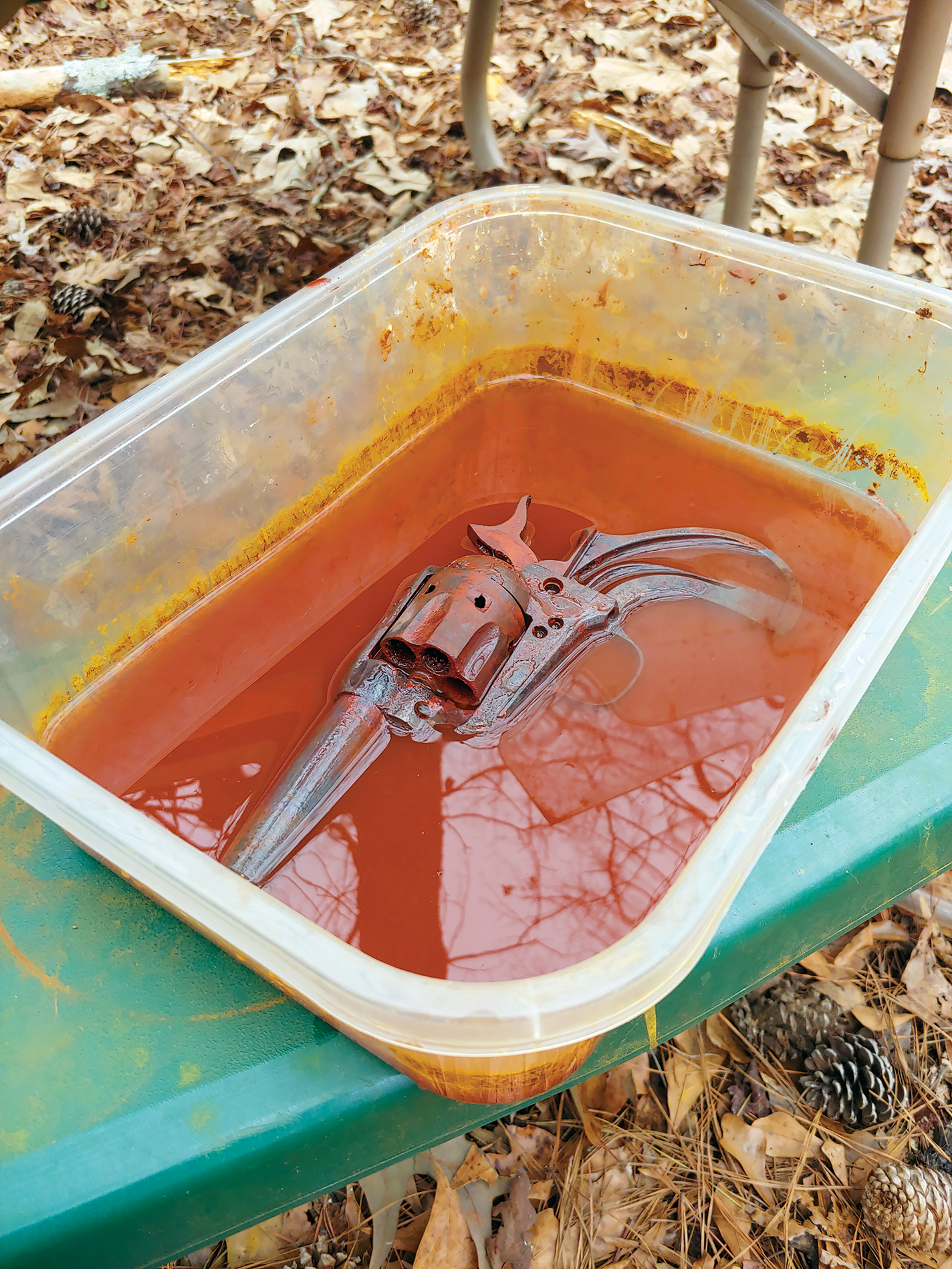 Iron oxide pigment being washed from 45-caliber revolver.