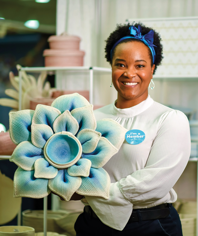 Tenisha Dotstry with one of her flower-shaped baskets.