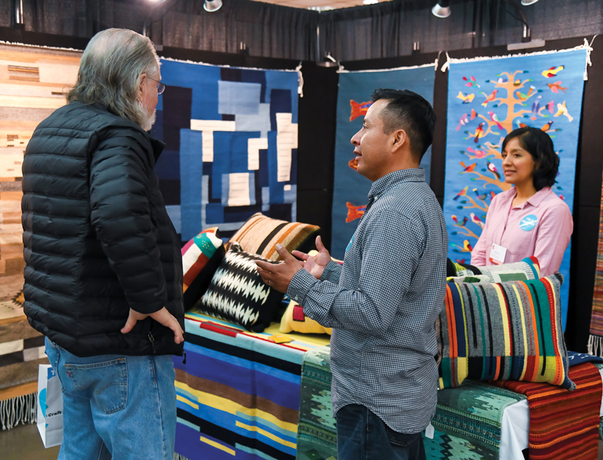 Francisco Bautista shows his textiles to customers at the February 2020 ACC show in Baltimore.