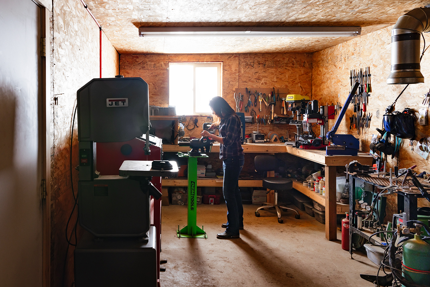 Amy Erickson in her shop, working at a vise.