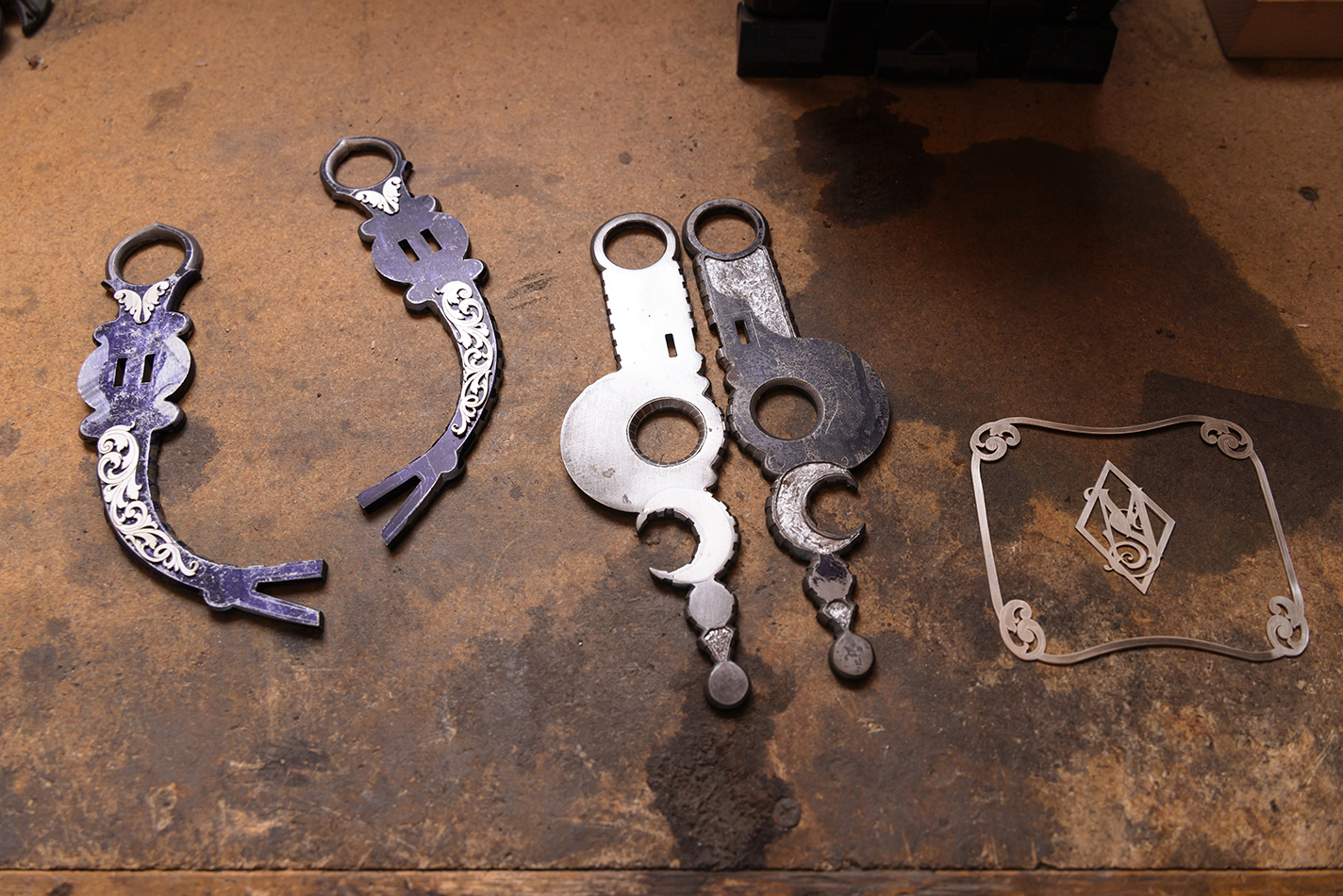 Two styles of bridle bits, one with filigree silver overlay and the other with sterling silver inlays.