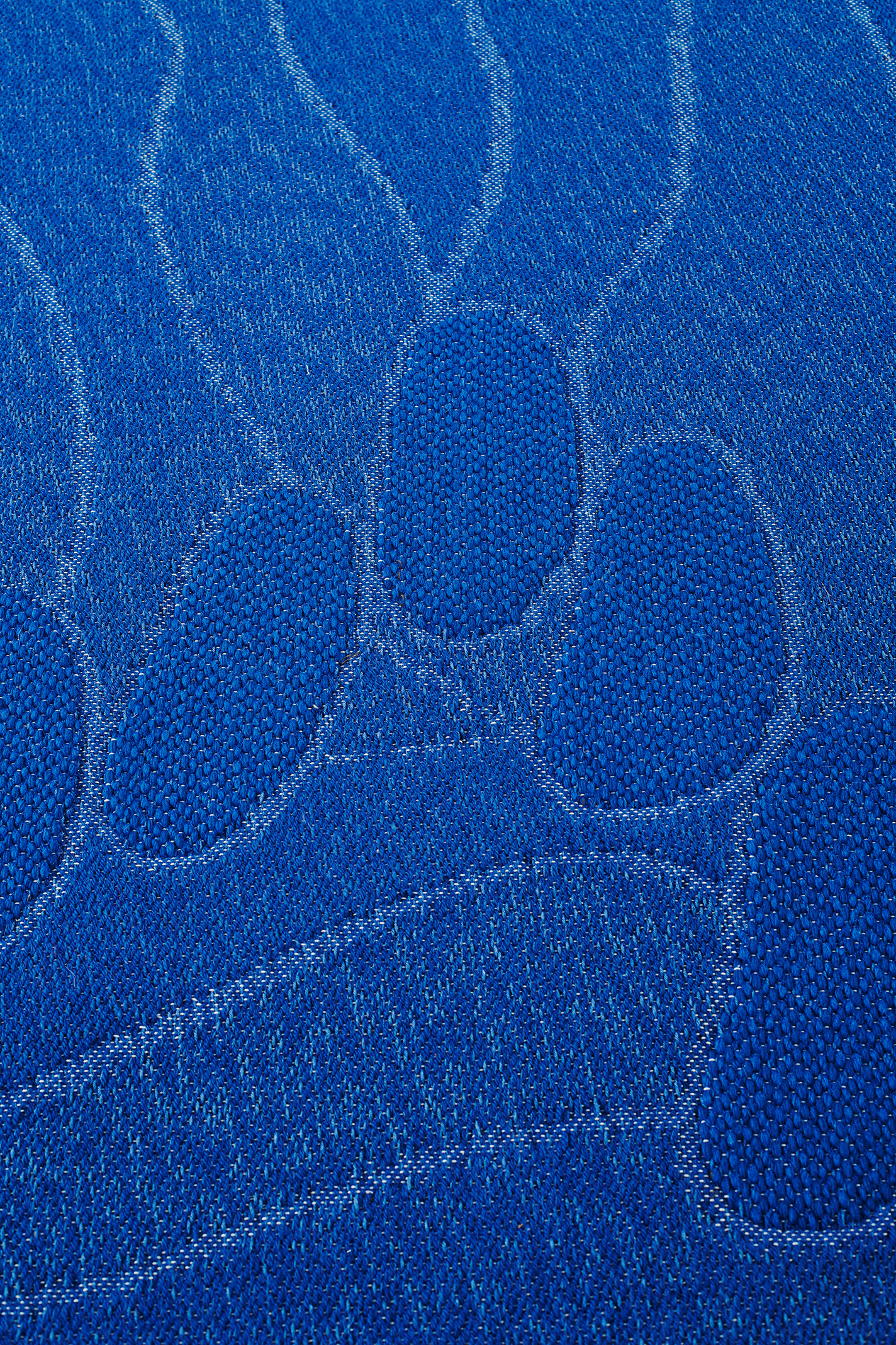 Detail shot of blue woven rug.