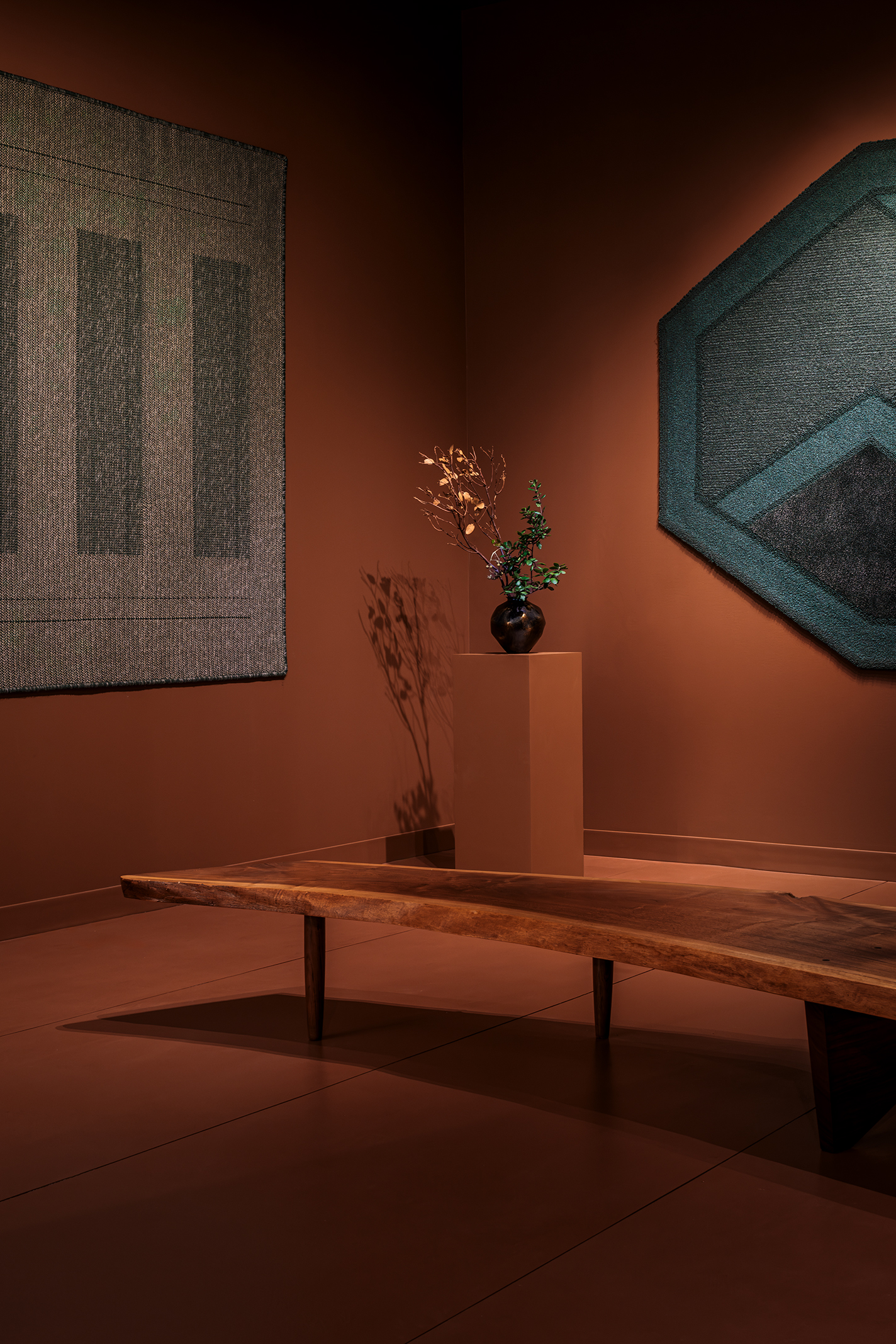 Installation shot from theDesign Miami 2024 Curio program exhibition, including Sylvie Johnson's rugs.