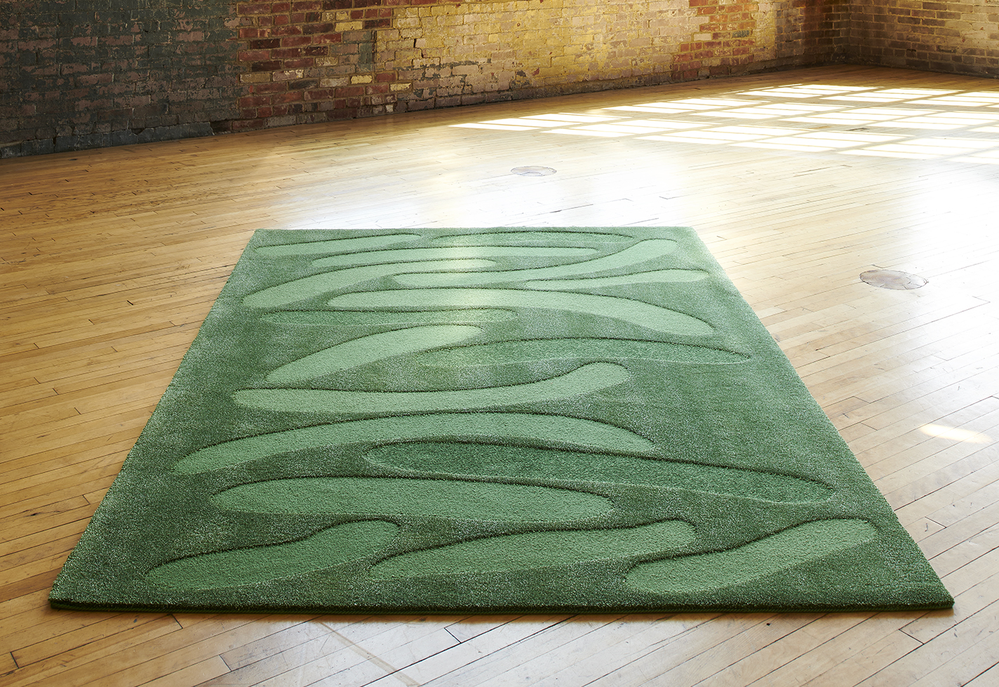 Green rug made from wool, linen, and alpaca merino yarns.