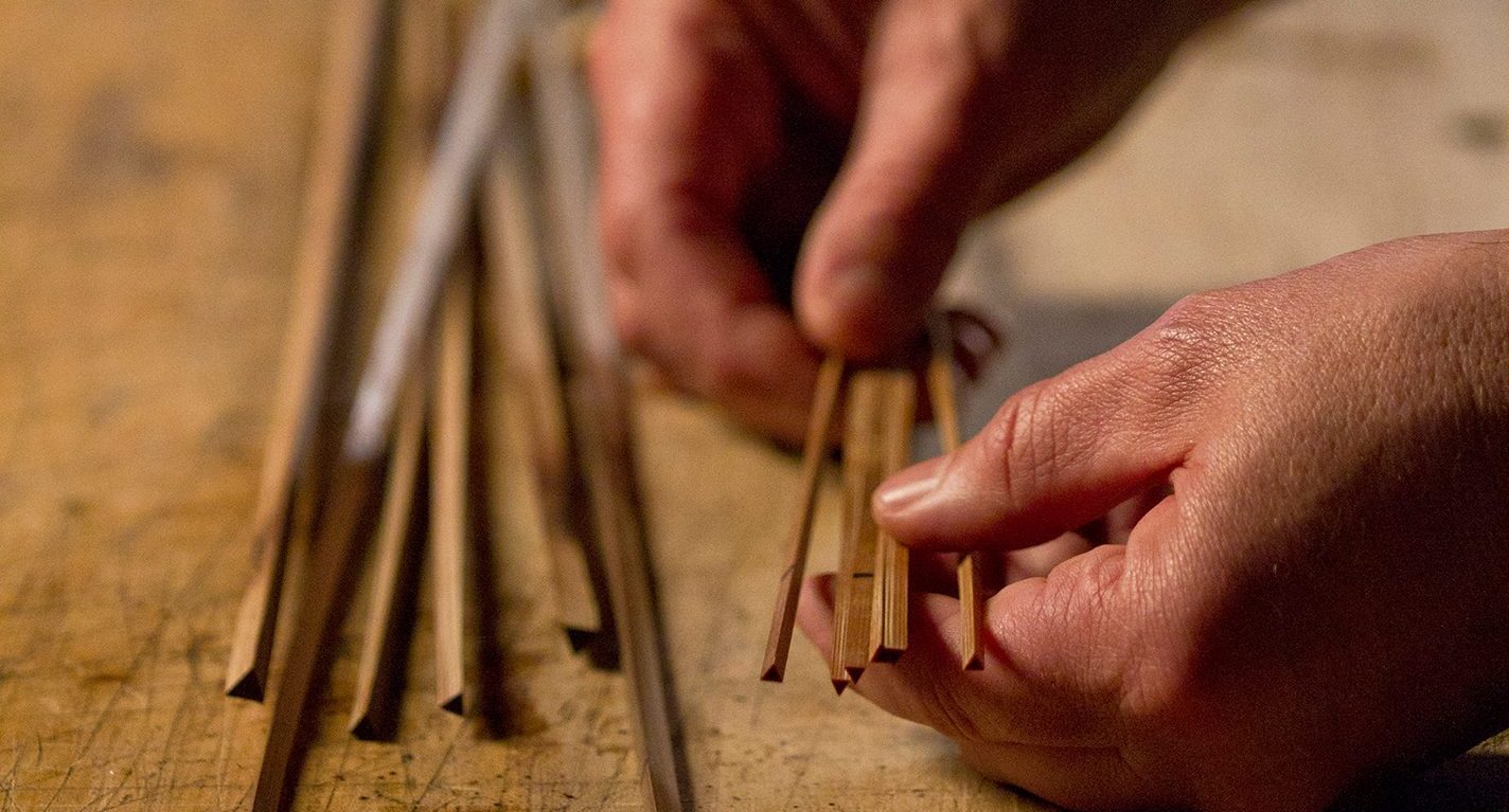 Bamboo culm split into quarter-inch strips, part of fly-rod making process.