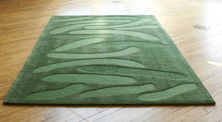 Green rug made from wool, linen, and alpaca merino yarns.