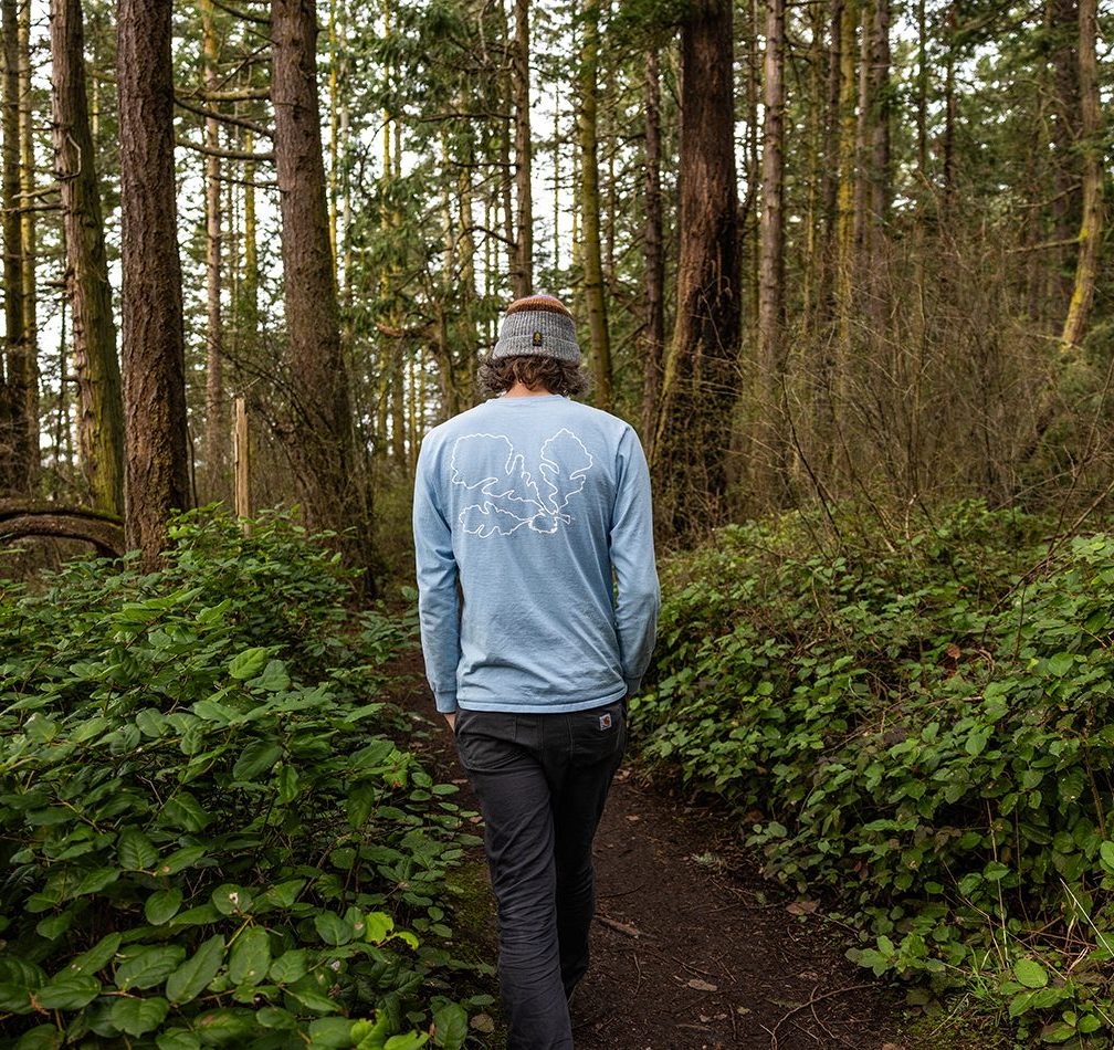 Back view of Kevin Reiswig walking in the woods.