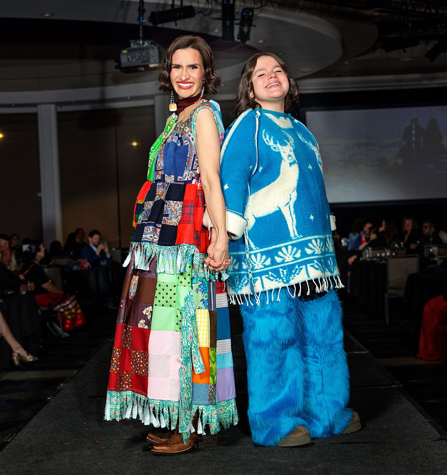 Peggy Flanagan walks the runway with her 12-year-old daughter Siobhan.