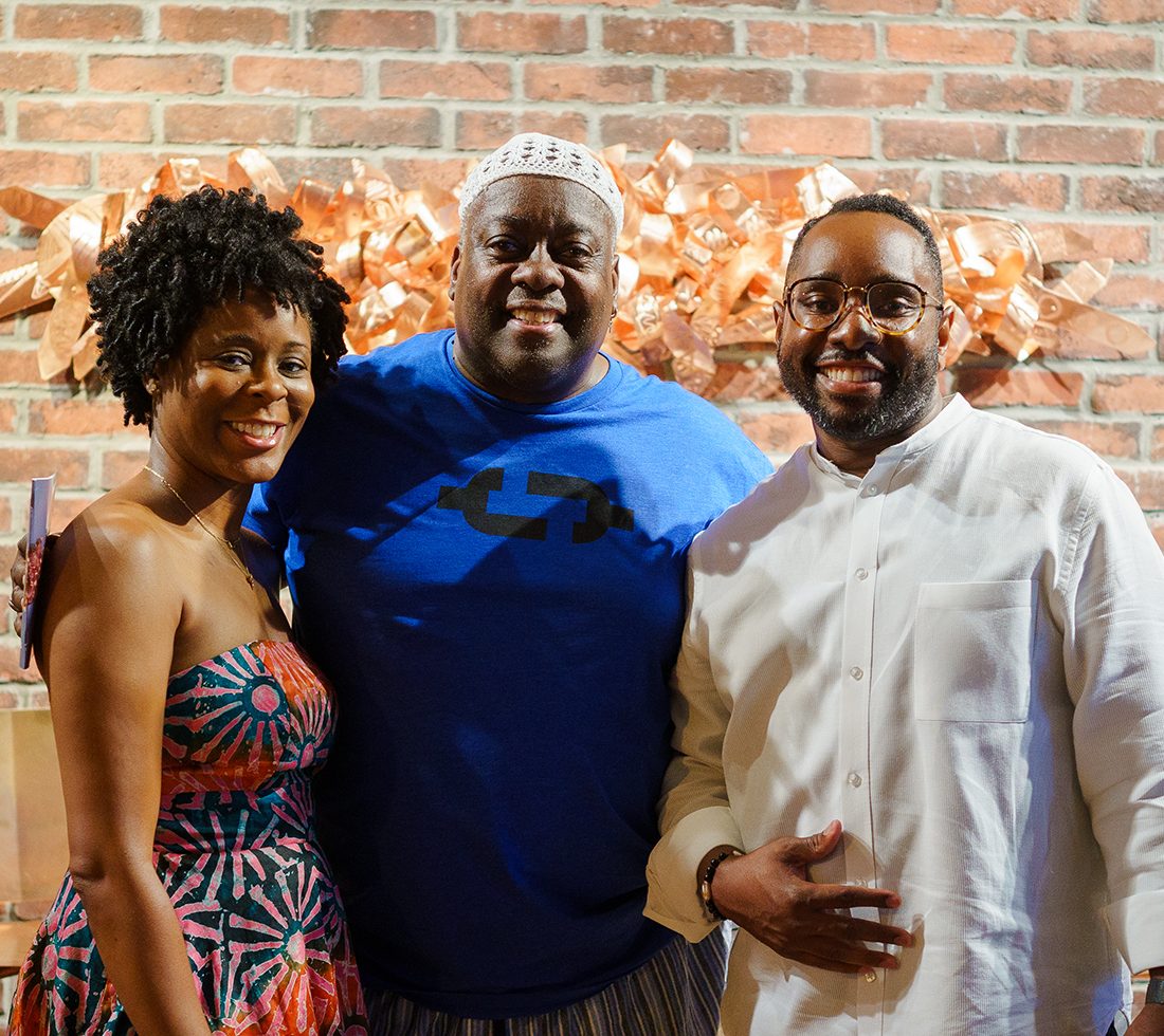 Esohe and George Galbreath and artist Kevin Cole in front of Cole's copper sculpture.
