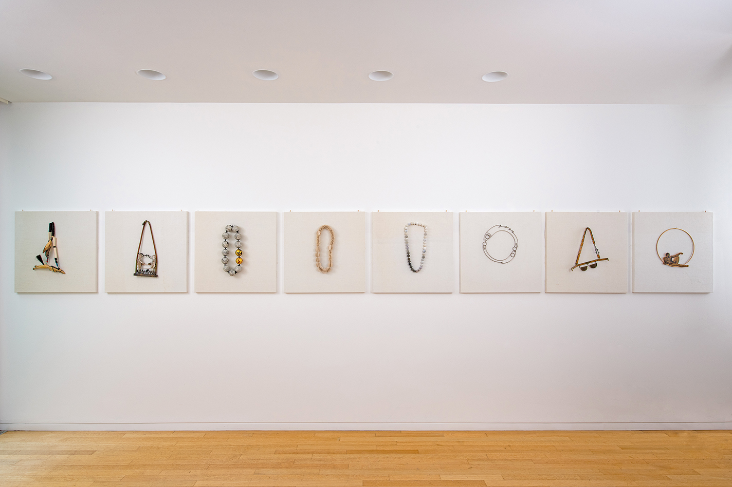 Sandy Grotta’s necklace collection displayed on the walls.