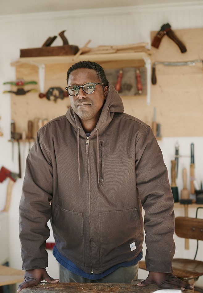 Robell Awake in his Atlanta studio with woodworking tools in the background.
