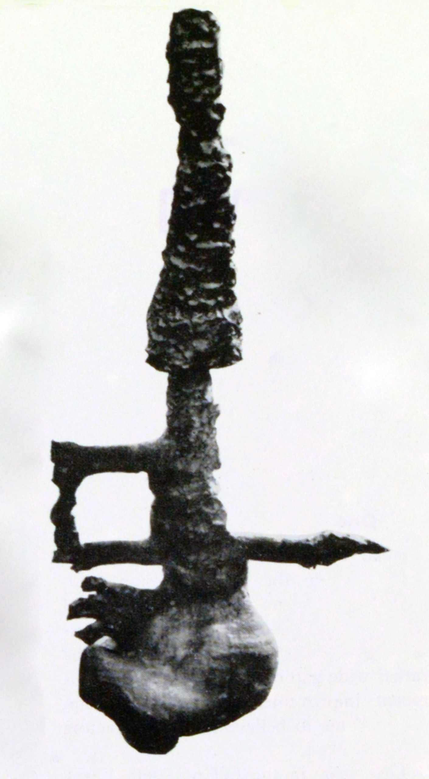 Tall, spindly ceramic sculpture.