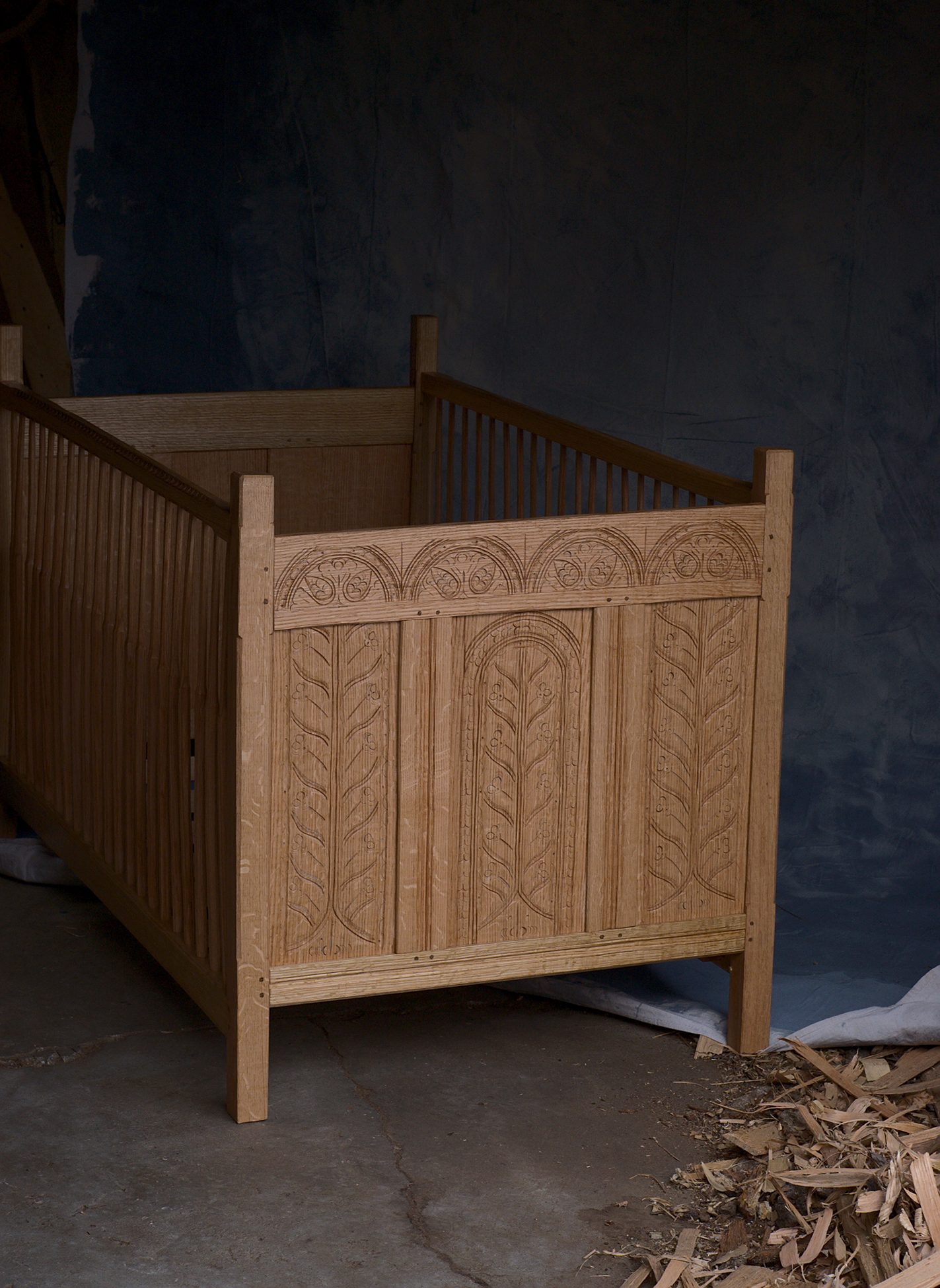Intricate baby crib made from red oak