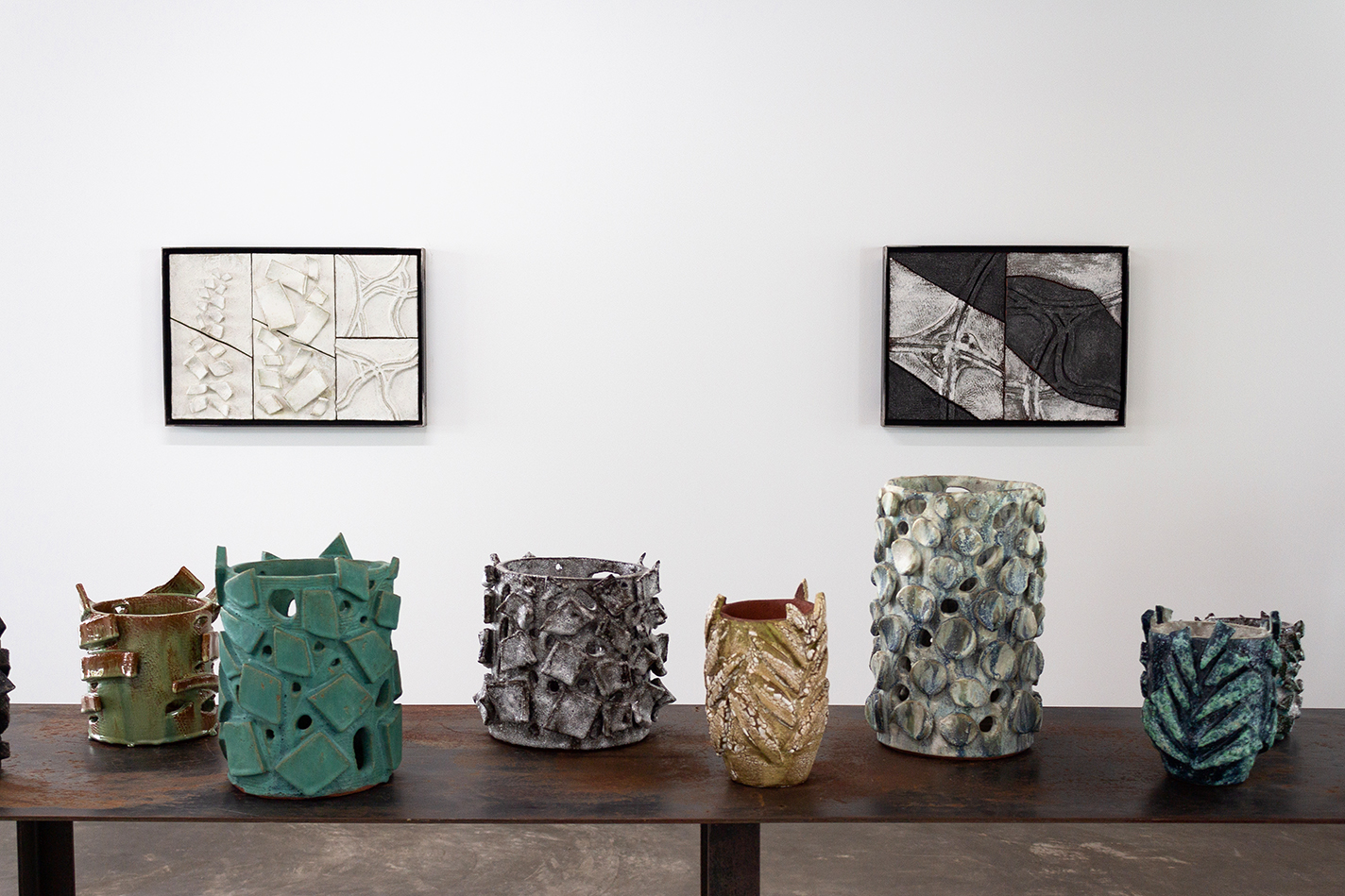Ceramic wall pieces and vessels in a gallery