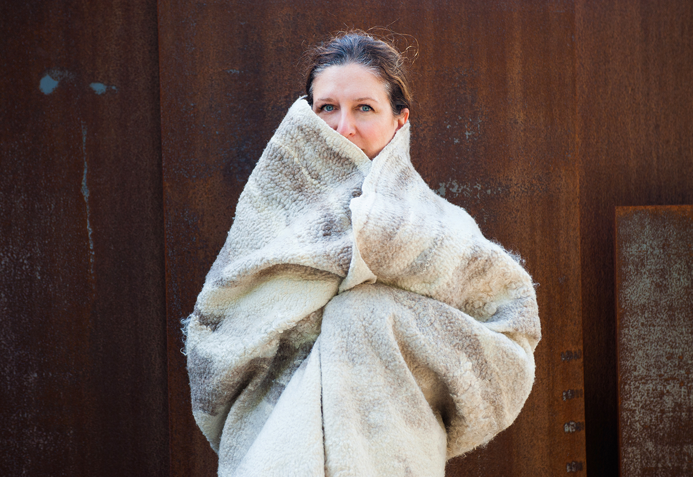Portrait of Kristin Colombano wrapped in a piece of her handmade felt