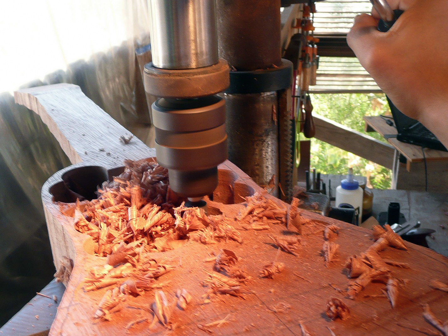 A drill press is used to carve out the body of a jarana.