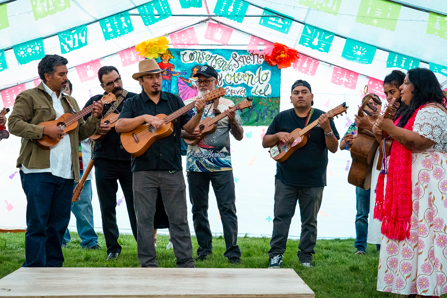 Musicians, dancers, and onlookers gather at a Milwaukee event center for a fandango, at which son jarocho music is played.