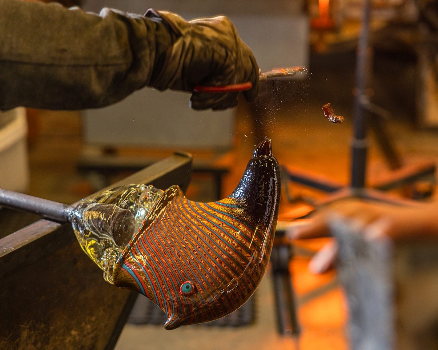 Friday shapes the nose of a cooled glass bear.
