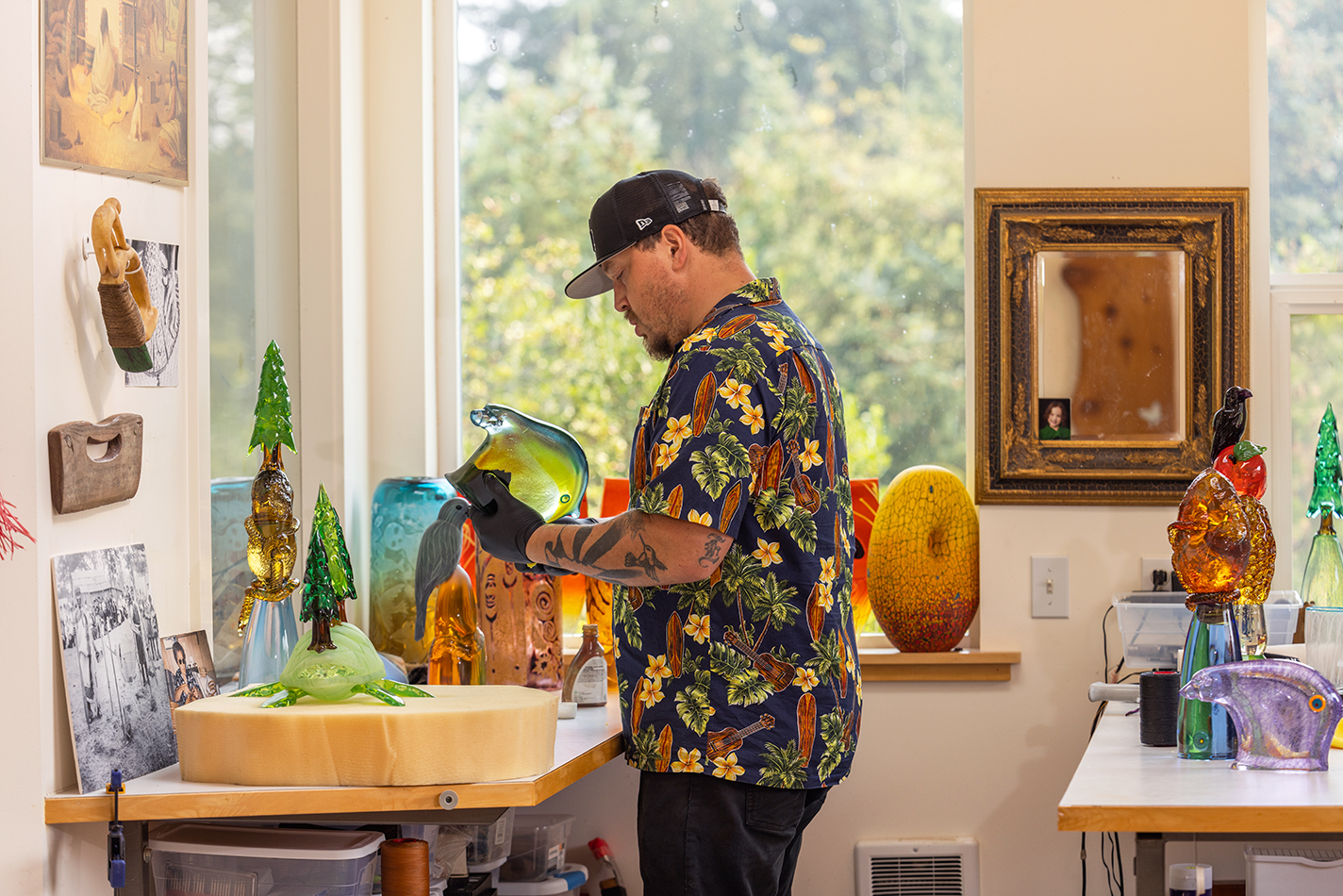 Friday in his studio holding a finished bear sculpture.