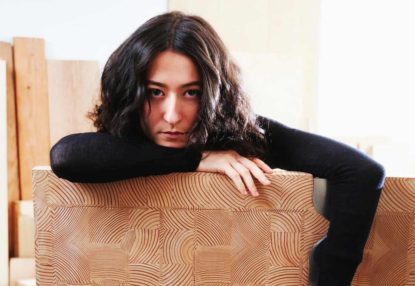 The artist poses with a piece of her work.