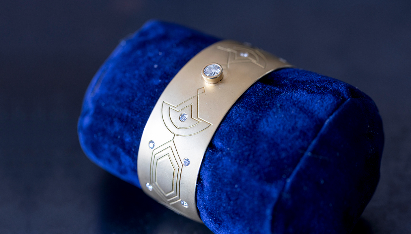 An 18k gold and diamond cuff with Kiowa beadwork designs.