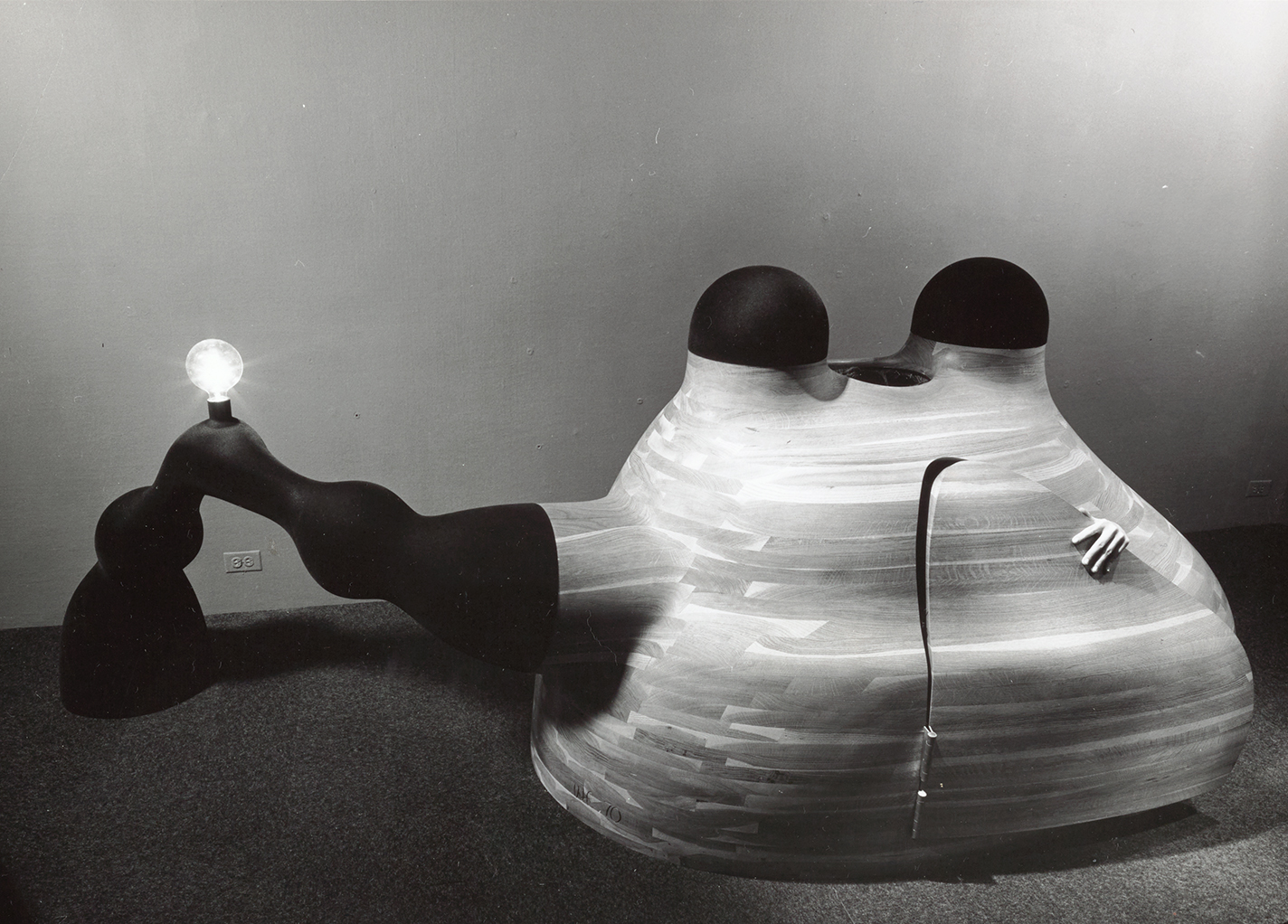 A hand peeks out of Wendell Castle’s oak and fiberglass structure.