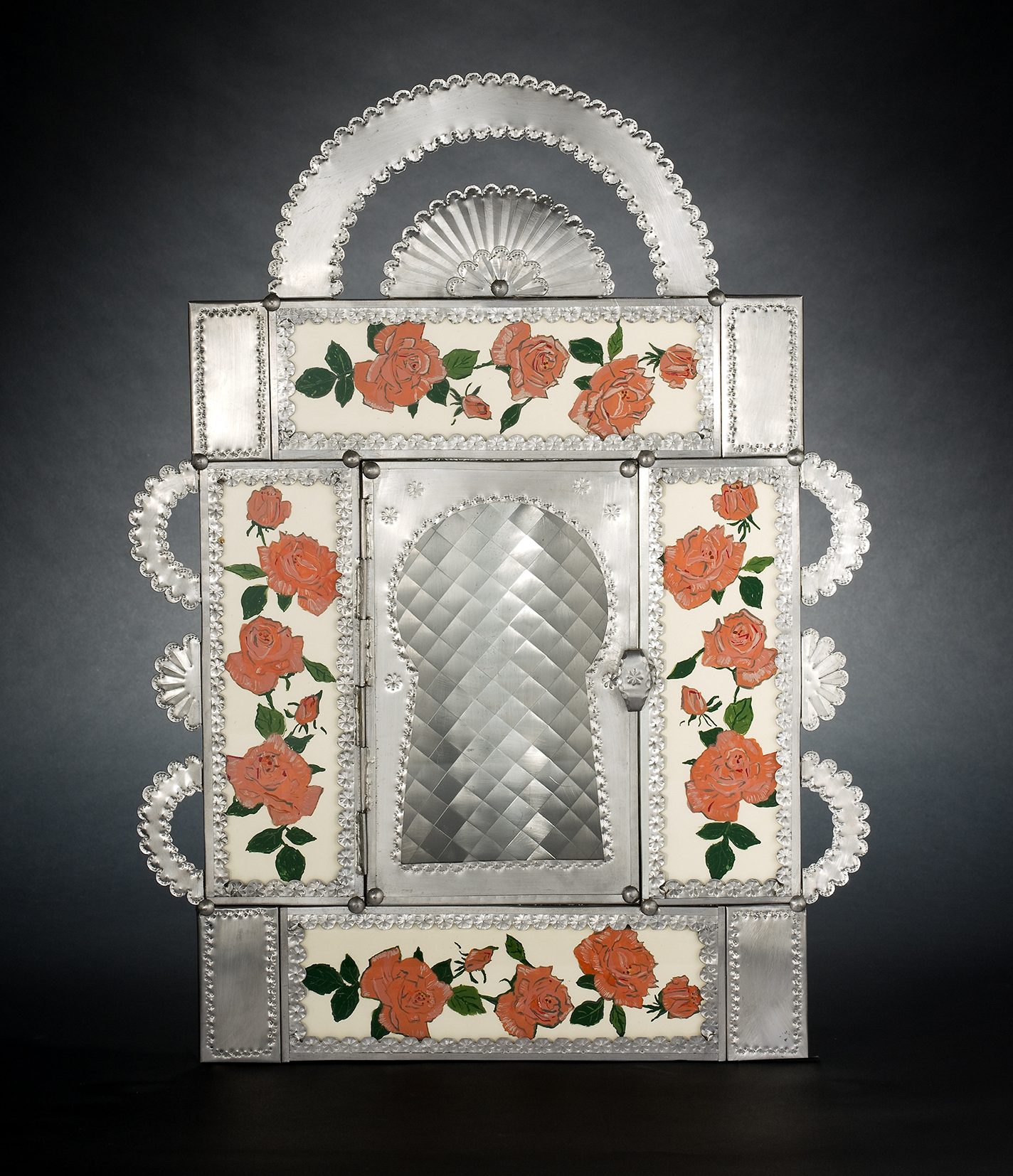 Hand-cut, hand-hammered tin creation with roses reverse-painted on glass